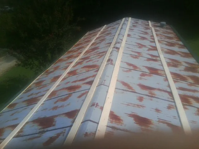 Rusted metal roof panels with new wood purlins before replacement — Storm Damage Roof Repair in North Charleston by Roofing Brothers